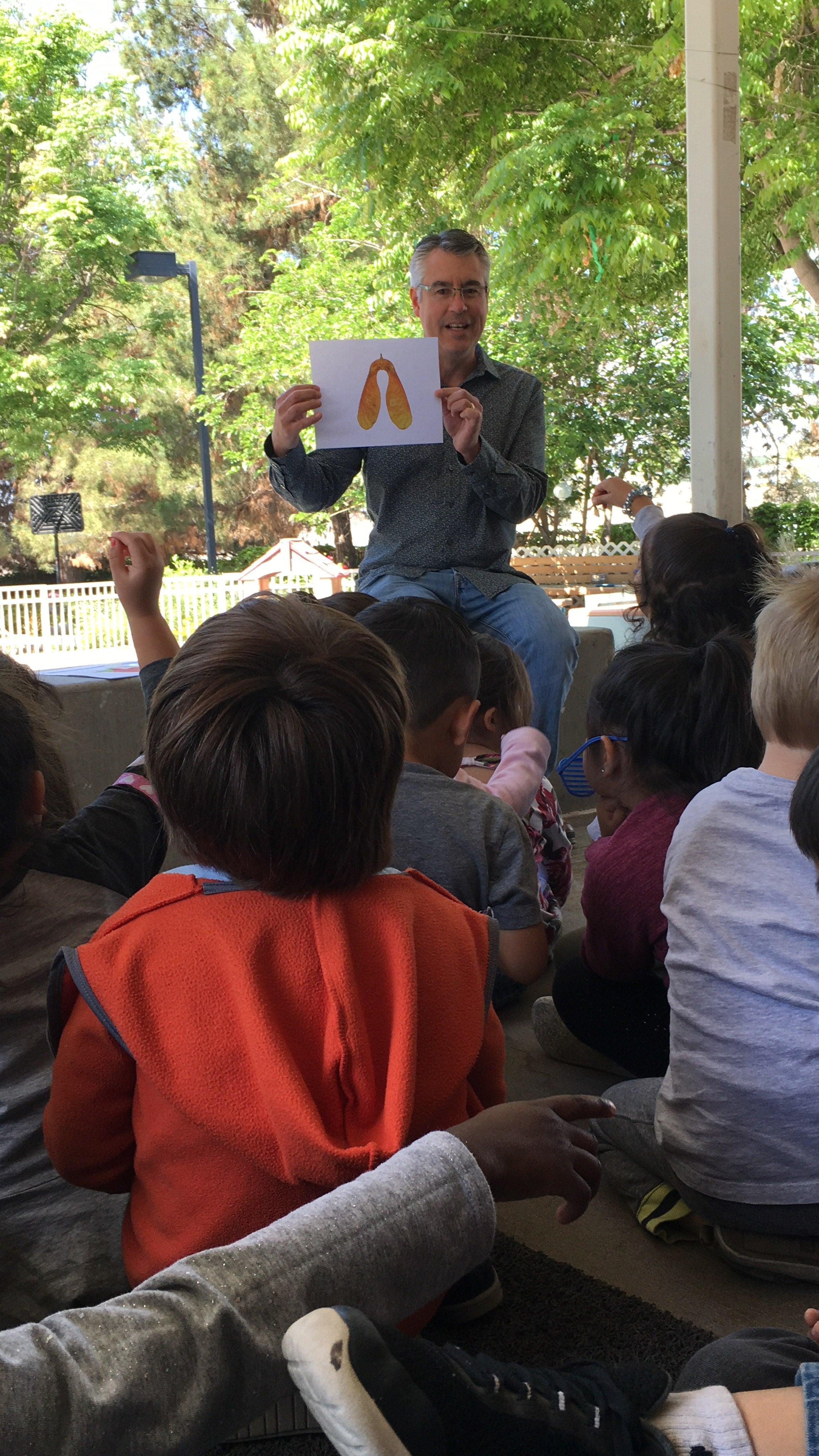 Professor Santiago giving a presentation to a pre-school class of children